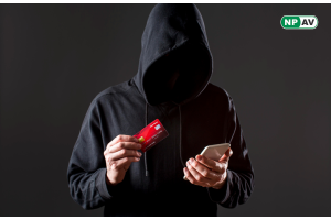 a hacker with mobile in one hand and card in another hand