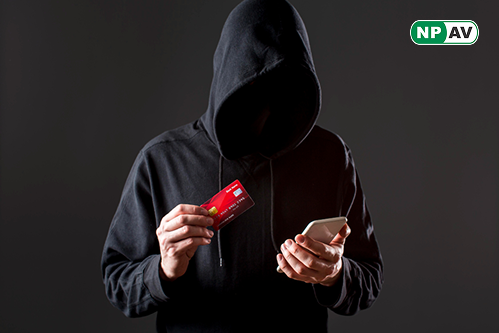 a hacker with mobile in one hand and card in another hand